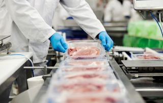 Close,Up,Of,A,Meat,Industry,Worker,Gathering,Packed,Meat